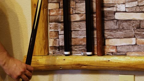 Cue-Sticks-On-Rack-On-The-Wall---close-up
