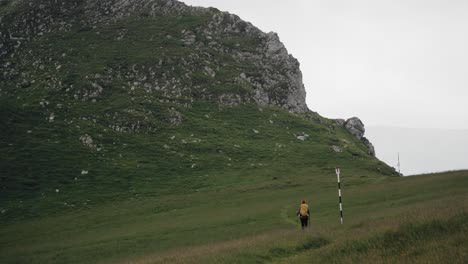 Hiker-walking-along-a-mountain-landscape