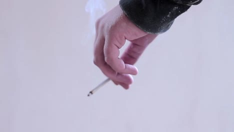 legalising-cannabis-smoking-cigarettes-with-hand-stock-footage