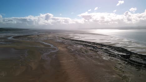 Hilbre-Island,-West-Kirby,-Wirral---aerial-drone-beach-horizon-forward