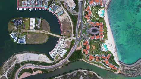 Aerial-view-above-resorts-of-Cap-Cana-Marina,-Punta-Cana,-in-sunny-Dominican-republic---top-down,-drone-shot