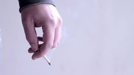 legalising-cannabis-smoking-cigarettes-with-hand-stock-footage