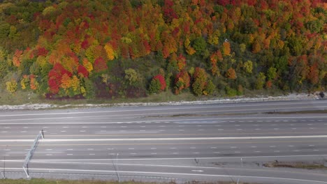 Fall-Aerial-timelapse-on-a-busy-highway-during-a-cloudy-and-sunny-day