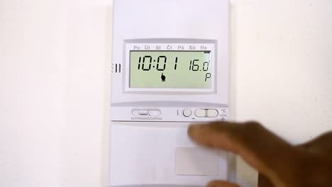 turn-the-heat-down-from-the-thermostat-due-to-high-rise-in-gas-bill-stock-footage