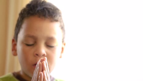 little-boy-praying-to-God-with-hands-together-stock-footage