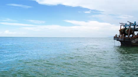 Ein-Verkleinerter-Schuss-Eines-Touristenboots-Auf-Einem-Wunderschönen-Ozean-Mit-Blauem-Himmelshintergrund