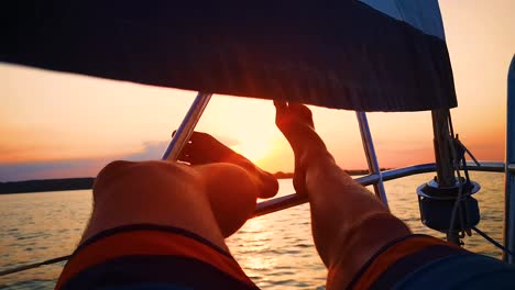 Close-Up-Shot-Relaxed-Traveler-Man-Legs-on-Motorboat-on-Beautiful-Island-and-Mountain-Carefree-Concept