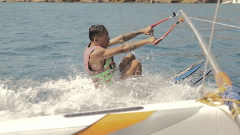 Young-man-learning-to-waterski