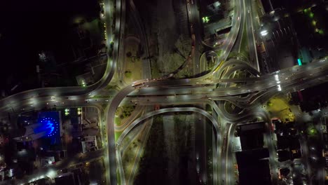 Aerial-view-above-traffic-on-a-intersection,-night-in-Monterrey-Obispado,-Mexico---top-down,-drone-shot