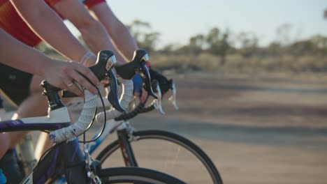 Hands-and-handlebar-close-up-tracking-shot-of-cyclists