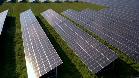 Close-up-solar-panels-with-sun-reflection---aerial-slowly-slide-panoram-right-to-left