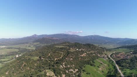 Aerial-dolly-shot-of-the-beautiful-landscape-in-medina-sidonia-in-cadiz-in-spain-with-view-of-the-hills,-trees-and-mountains-in-the-background-on-a-sunny-day