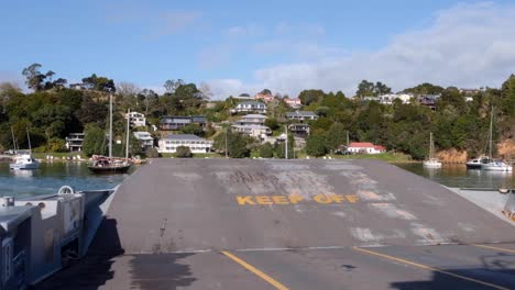 Passenger-and-car-ferry-boat-with-ramp-up,-keep-off,-during-crossing-to-town-of-Okiato,-Old-Russell,-Bay-of-Islands,-New-Zealand-Aotearoa