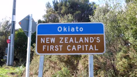 Signpost-for-beautiful,-historic,-coastal-town-of-Okiato,-New-Zealand's-first-capital,-in-NZ-Aotearoa