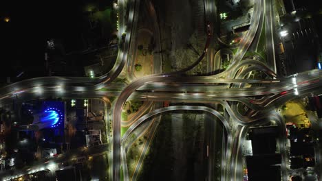 Hyperlapse-aerial-above-traffic-in-a-illuminated-junction,-evening-in-Mexico---Cenital,-drone-shot