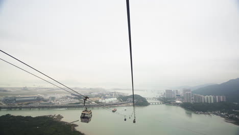 Cable-Car-above-river-and-mountains-in-aerial-view