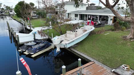 Boat-displaced-and-strewn-on-lawn-in-aftermath-of-hurricane-in-Florida