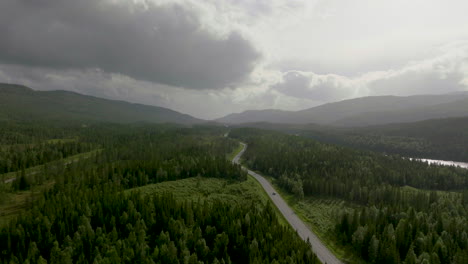 Traffic-Along-E6-Highway-Passing-By-River-Namsen-Near-Namsskogan,-Norway