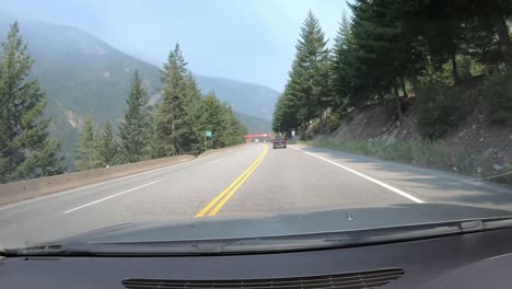 Car-Drives-Through-Mountain-Landscape-Sunny-Day-Dash-Cam-POV-Timelapse