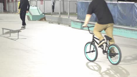 Slow-motion-at-skate-park-with-BMX-riders-and-skate-boarders-at-night