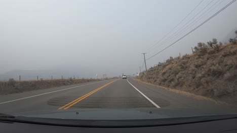 Point-of-View-Driving-Car-in-Misty-Mountain-Landscape-Time-Lapse