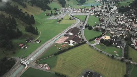 Antena-De-Drones-Sobre-Una-Pequeña-Ciudad-De-Endelberg-En-Suiza-Que-Muestra-Un-Río-Azul-Limpio-Y-Un-Lago-En-Un-Día-Nublado-Cerca-De-Las-Montañas