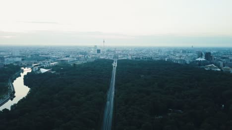 Drone-aerial-over-road-towards-Berlin-city-with-river-in-shot