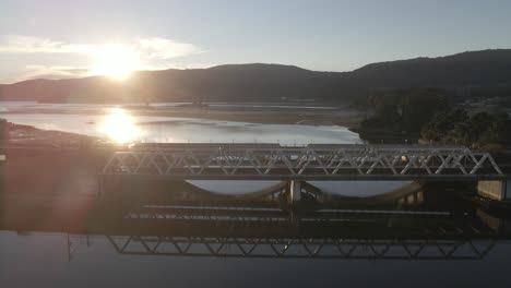 Aerial-drone-forwarding-shot-over-medieval-bridge-called-Sampaio-on-the-Verdugo-river-located-in-Arcade-town,-Pontevedra,-Galicia,-Spain-at-sunrise