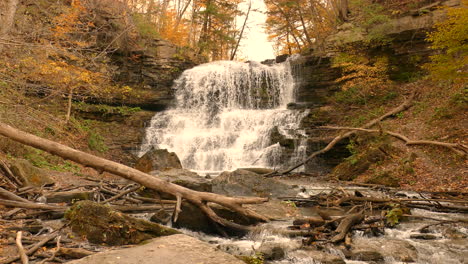 A-cascading-waterfall-in-a-wooded-area-with-orange-and-brown-tones