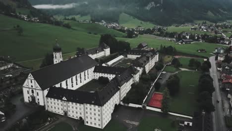 Drone-aerial-over-large-courtyard-and-showing-the-whole-town-of-Endelberg-abbey-in-Switzerland