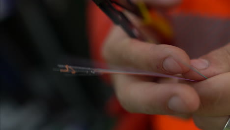 A-close-up-shot-of-a-technician-is-cutting-fiber-optic-cables