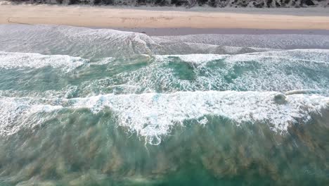 Drone-aerial-at-beach-Great-Ocean-Road-with-deep-blue-waves-and-sand