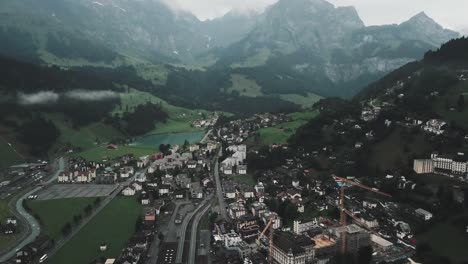 Drone-aerial-move-backwards-and-pan-up-over-the-town-of-Endelberg-in-Switzerland-showing-mount-titlis