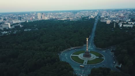 Drone-aerial-over-Berlin-Victory-Column-during-sunrise-slow-pan-with-cars-on-road