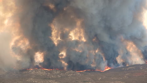 Mesmerizing-view-over-a-frightening-wildfire-with-heavy-black-smoke-rising