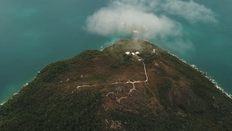 Drone-aerial-above-clouds-on-tropical-forest-Fitzroy-island-on-summer-day