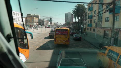 POV-handheld-of-the-Argentinean-avenue-of-Valparaiso,-Chile-full-of-traffic