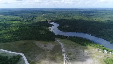 Aerial-drone-forward-moving-shot-of-picturesque-winding-river-from-above-surrounded-by-lush-green-forest-at-daytime-in-Parintins,-Amazonas,-Brazil