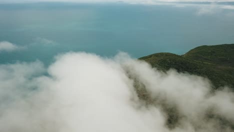 Drone-aerial-above-the-clouds-at-Fitzroy-tropical-island-showing-the-great-barrier-reef