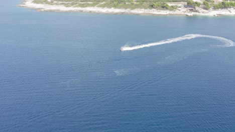 Jet-Ski-on-ocean-between-Islands-in-Ksamil-Albania,-Drone