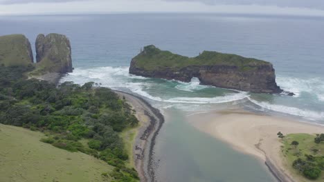 Aerial-hole-in-the-wall-transkei-wild-coast-beach-with-rolling-green-hills,-drone-south-africa