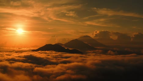 Mountain-view,-epic-landscape-of-clouds-and-mountains-appearing-from-it-while-sun-goes-into-dusk