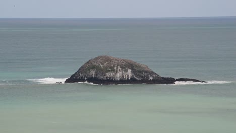 Giant-rock-forming-a-small-island-off-New-Zealand's-northern-east-coast