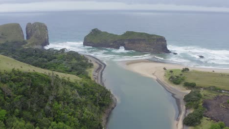 Drone-over-water-canal-leading-into-ocean-hole-in-wall-transkei-beach,-south-africa