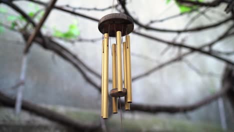 Wind-Chimes-With-Gold-Tubes-Hanging-In-The-Garden