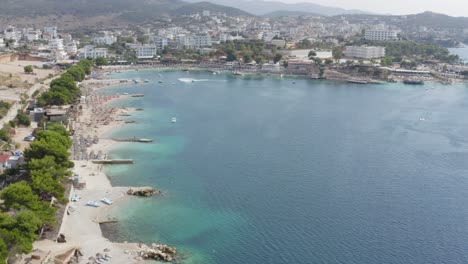 Drone-flying-over-Ksamil-Beaches-and-Restaurants-on-Mediterranean-Sea-in-Albania-and-Greece