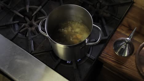Stock-pot-on-stove-in-farmhouse-kitchen