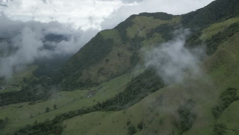Flying-above-Cocora-Valley-Andean-Dark-Green-Mountains-in-Salento-Colombia-Cloud-Coming-Through,-Los-Nevados-National-Park