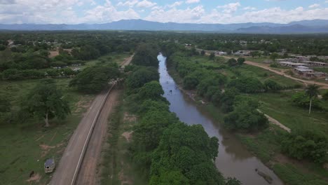Drone-shot-of-wall-and-river-divide-Haiti-and-Dominican-Republic-in-rural-area