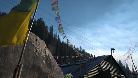 Slow-Motion-Clip-of-Himachal-Tea-Shop-in-Sethan-Manali-Colourful-flags-and-treeline-behind-cinematic-aesthetic-travel